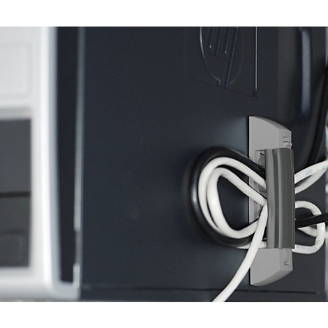 Close-up of a black PC case with cable holder. Black and white cables are neatly arranged. HP logo.