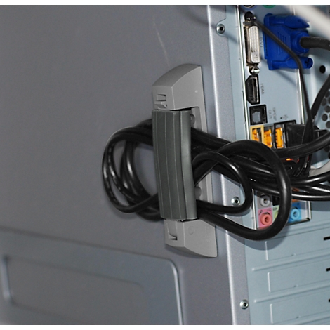 Gray cable holder on a computer case. Black cables stowed inside.