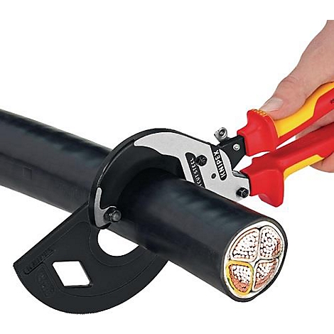 Hand with red-yellow pliers cutting thick black cable. Cut surface shows copper wires.