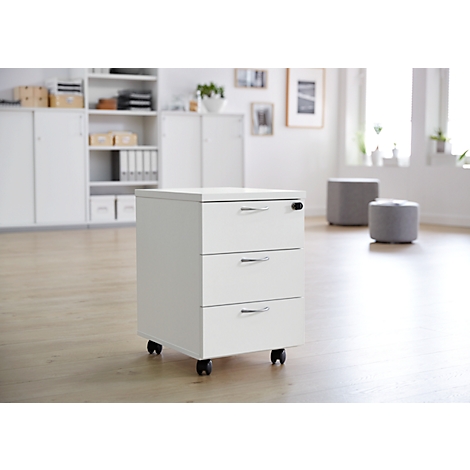Classeur mobile blanc avec trois tiroirs dans un bureau lumineux.