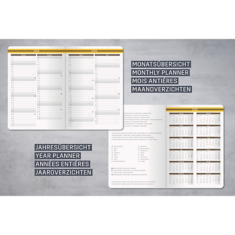 Carnet ouvert avec vue d'ensemble annuelle et mensuelle. Différentes langues sont affichées.