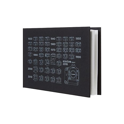 Schwarzes Notizbuch mit weißer Grafik historischer Canon Kameras und Jahreszahlen.