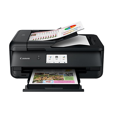 Schwarzer Canon-Multifunktionsdrucker. Auf dem Scanner liegen Diagramme, gedrucktes Papier kommt aus dem Ausgabefach.