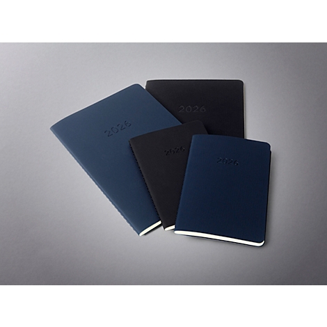 Vue de dessus de carnets de différentes tailles et couleurs, tous avec l'année 2026 en relief.
