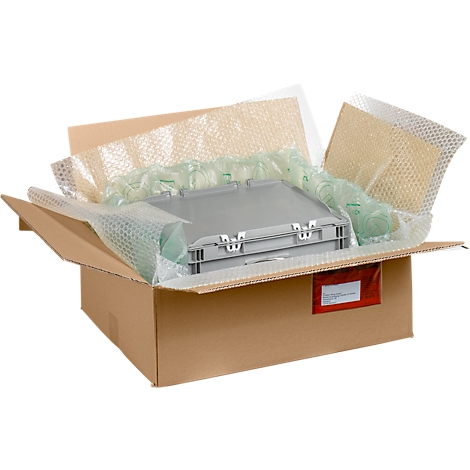 Valise grise emballée dans une boîte en carton ouverte avec du papier bulle.