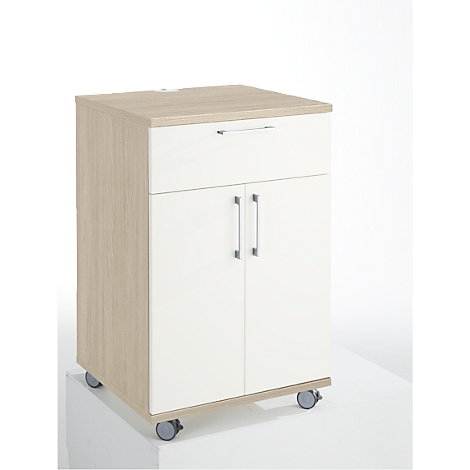 A white and beige cabinet on wheels with a drawer and double door. The cabinet stands on a white surface.