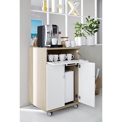 Coffee machine on a wooden cabinet with a fold-out door. White cups and plants decorate the furniture.