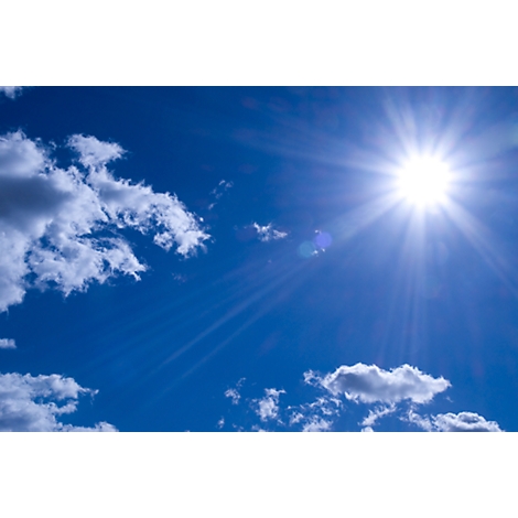 Blue sky with sun and clouds. The sun shines brightly, surrounded by rays of light.