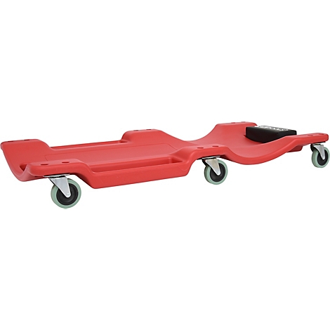 Chariot de mécanicien rouge avec roulettes. Il a quatre roulettes et un appui-tête rembourré.
