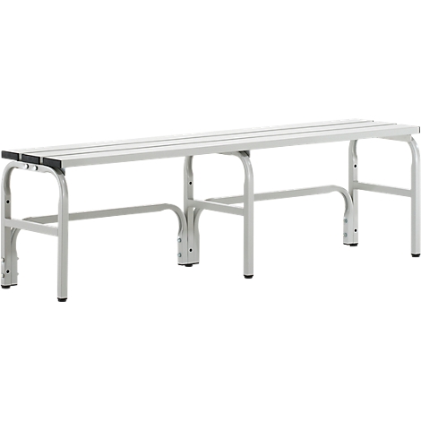Grey bench with elongated seating surfaces and curved legs. The bench is made of metal and stands on the ground.