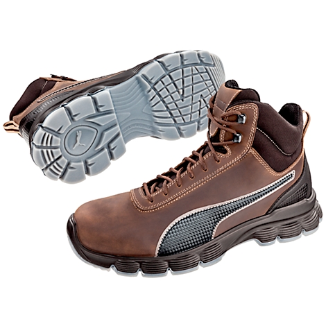 Botte de sécurité Puma marron, gros plan. Semelle et logo Puma clairement visibles.