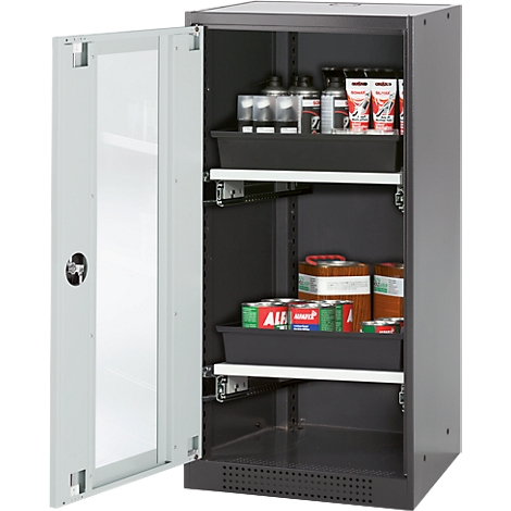 An open grey cabinet with shelves filled with containers and cans. The door has a glass front.