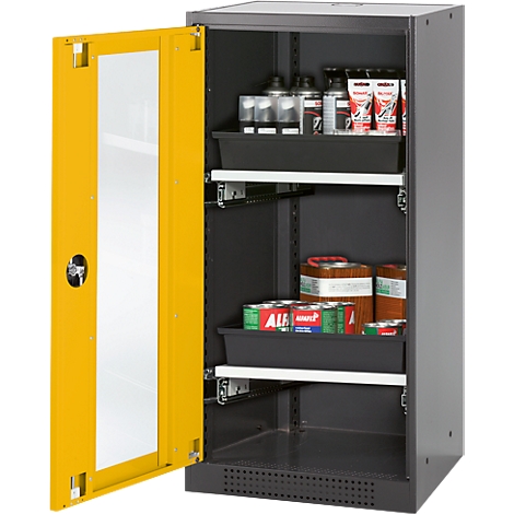 An open yellow cabinet filled with chemicals. The door has a window, the cabinet has black drawers.