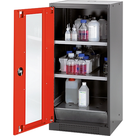 Cabinet with red door, open, showing bottles and containers filled with liquids.