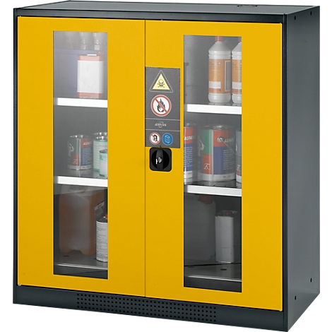 Yellow and black safety cabinet with glass panels, filled with various containers. Warning signs and a lock are visible.