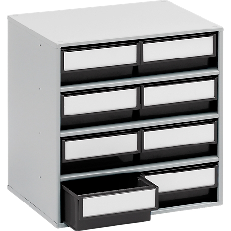 Gray rectangular cabinet with nine drawers, one is open. Each drawer has a white label and a black frame.