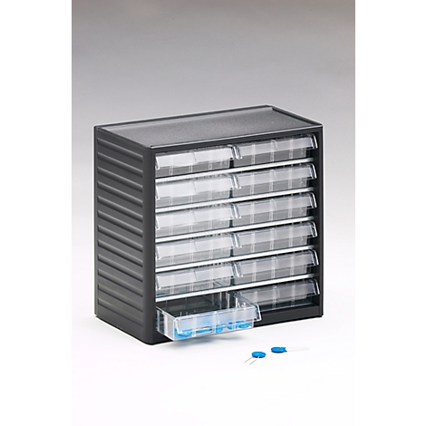 Dark drawer box with transparent drawers. One drawer is slightly open, next to it are blue objects.