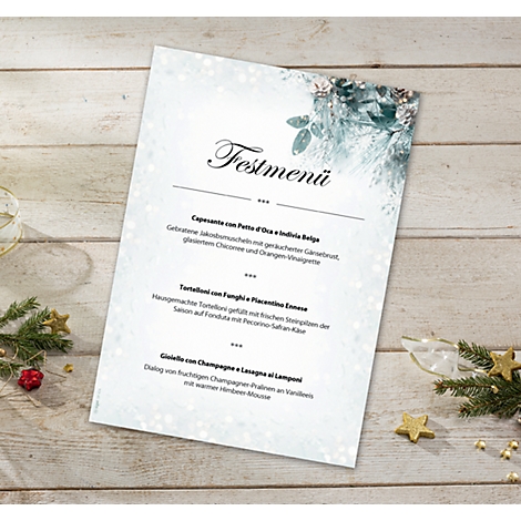 Menu card with Christmas design. Text: Festive menu. Decorated on a wooden table with fir branches and stars.