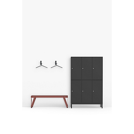 Vestiaires gris, un banc marron et des cintres contre un mur blanc.