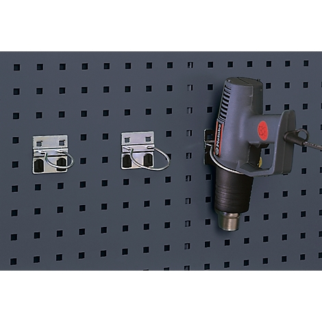 Heat gun with holders on a pegboard.