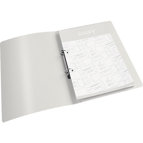 Classeur gris avec bloc de papier en vrac. "cosy" est écrit sur le bloc en lettres gris clair. Le papier est imprimé avec des motifs gris clair.