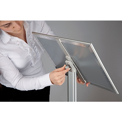 Person adjusting a silver presentation lectern.