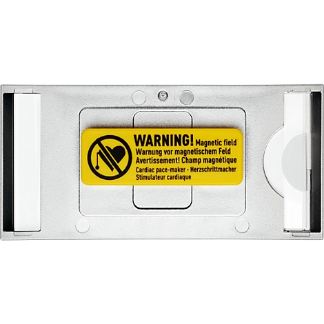 Metallic plate with a yellow warning sign. It warns about magnetic fields and pacemakers, with a symbol and texts in German, English, French.
