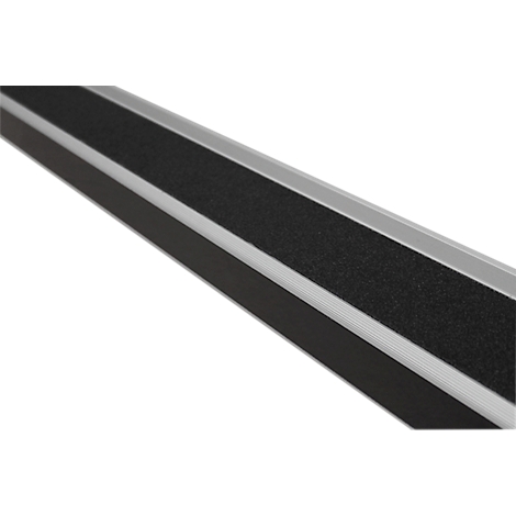 Gray strip with black, rough surface, diagonally from bottom left to top right. Details show the texture of the surface.