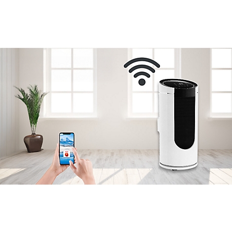 Un radiateur blanc avec commande par smartphone devant une fenêtre. Une application qui contrôle le radiateur est ouverte sur le smartphone.
