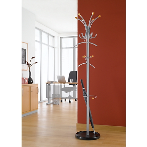 Silver coat rack with golden knobs. Black umbrella inside the stand.