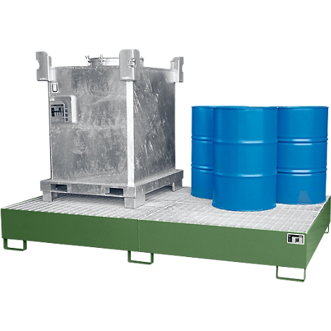 Large metal container and blue barrels on a green spill containment pallet.