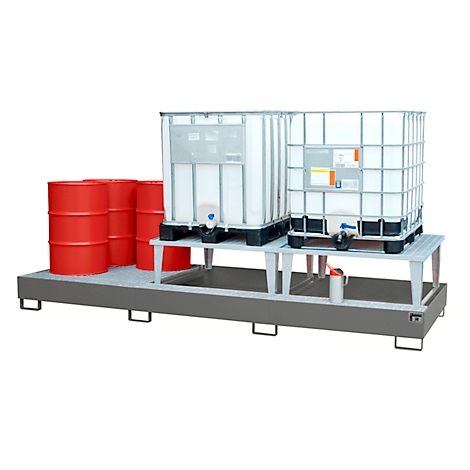 Metal spill containment with barrels and IBC tanks. Red barrels on the left, white IBC tanks on an elevated platform.