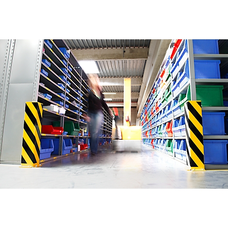Warehouse with shelves and boxes, blurred person in the aisle.