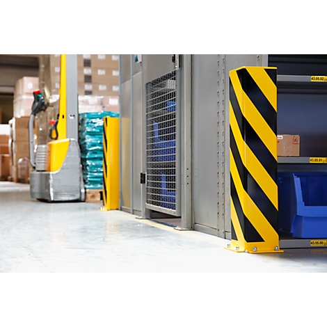 A warehouse area with forklift, shelves and a protective post with yellow and black diagonal stripes.