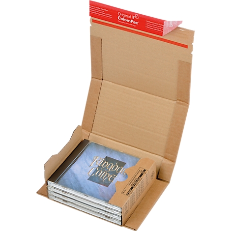 An open brown cardboard box containing a CD case labeled "Kingdom Come". A red stripe on the lid.