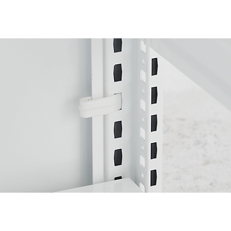 Gros plan sur un système d'étagères blanc. Un clip en plastique blanc maintient une partie d'étagère blanche.