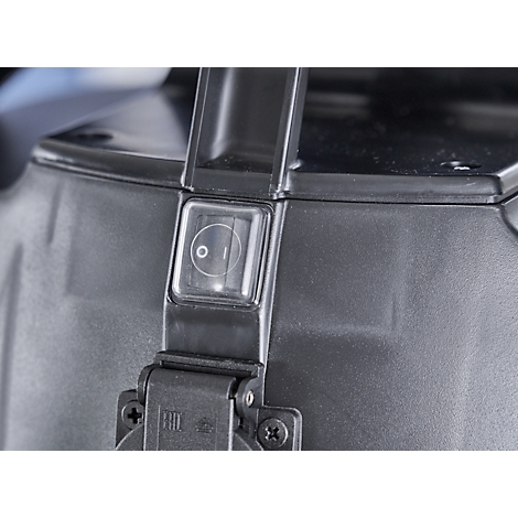 Close-up of a black plastic device. A transparent on/off switch with the characters 0 and I is visible. The handle is black.