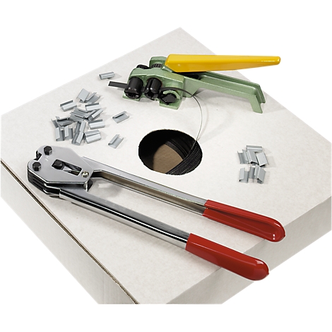 Packaging set with two tools, metal clips and tape on a white surface.