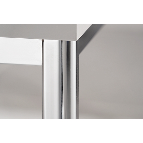 Corner of a white table with a shiny metal leg support.