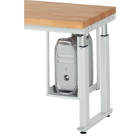 View of a desk with a computer case attached to the underside. The desk frame is silver, the tabletop is made of wood.