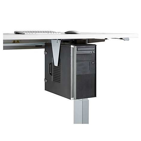 A black PC attached to a bracket under a white desk. A keyboard and mouse are visible on top.