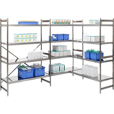 Stainless steel shelving in a lab or industrial setting. Shelves hold containers, boxes, and bottles.