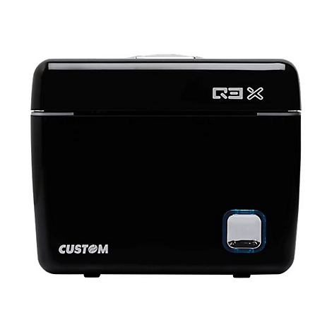 Boîte noire rectangulaire avec les textes "R3X" et "CUSTOM". Un bouton éclairé en bas à droite.
