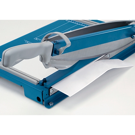 A blue and gray paper trimmer, with a white sheet of paper that is being cut.