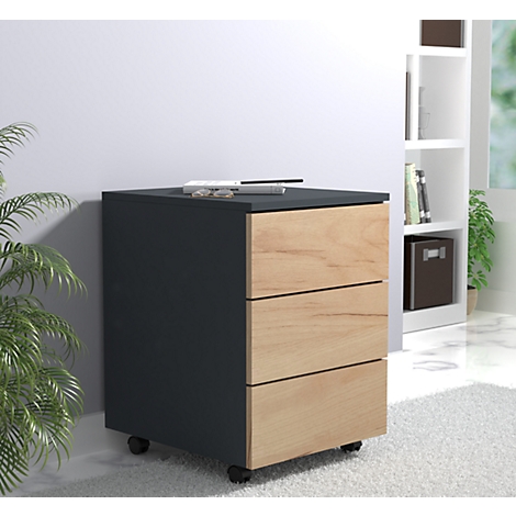Dark gray filing cabinet with three drawers, wooden fronts, black lid, castors. Glasses and pen on top.