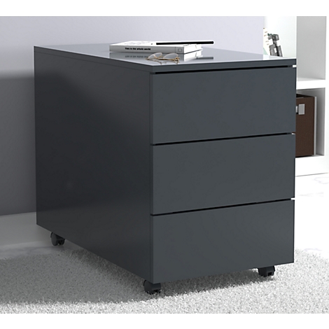Dark gray rolling cabinet with three drawers. A book and glasses are on top.