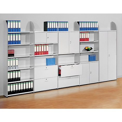 White office furniture with binders in different colors, cabinets and drawers.