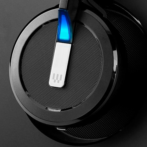 Close-up of black headphones with blue illuminated detail and logo.