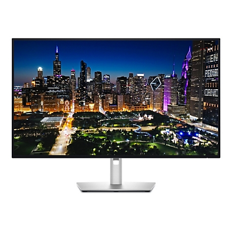 Ein Computermonitor mit einem nächtlichen Stadtpanorama im Display, mit hohen Gebäuden und bunten Lichtern.