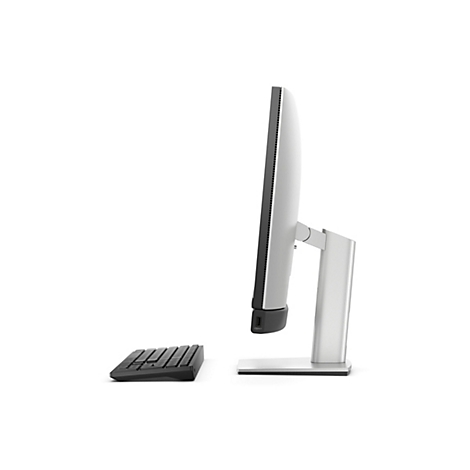 Ein Computerbildschirm im Profil mit angeschlossener Tastatur vor weißem Hintergrund.
